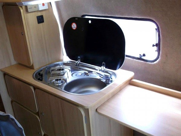 Kitchen sink and cupboard in  campervan conversion by Céide Campervan Conversions, Donegal,  Ireland